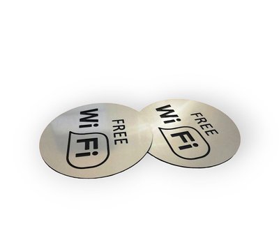 Round plate with WI-FI Free zone symbol with adhesive tape on the wall