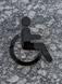 Universal accessibility symbol ISO 7001 made of black acrylic, person in wheelchair sign. 3D, modern, minimalist, restaurant, hotel door sign - self-adhesive